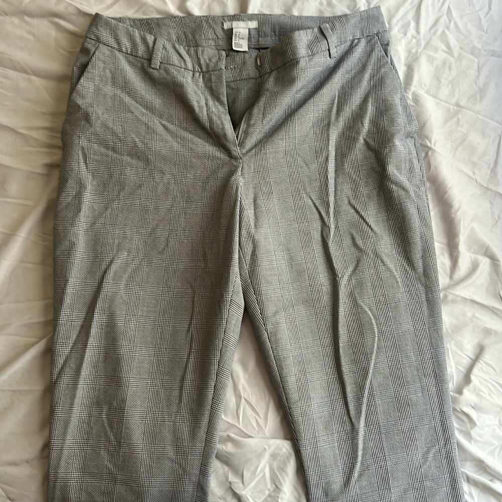 3 dress pants. One patterned black and white. One all black. One light gray.